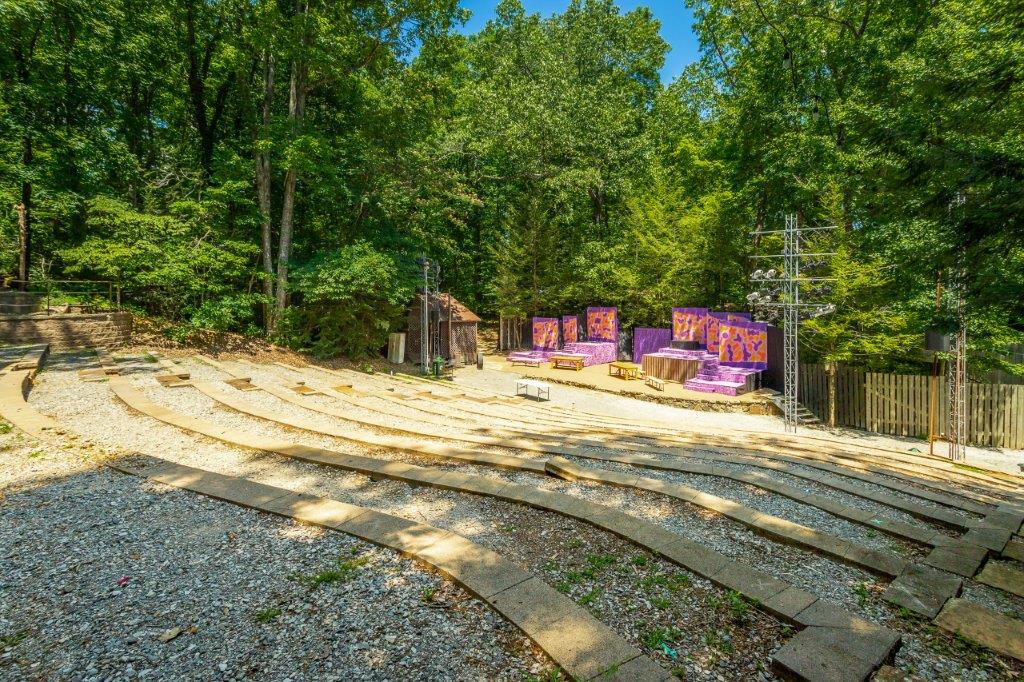 Photo of the Signal Mountain Playhouse. An outdoor theater located on Signal Mountain, TN. Stage is downhill with stone rows of seats.