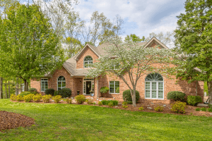 Row of past Chattanooga houses for sale listed by KW Jay Hudson Homes. large brick 2 story home with landscaped yard including pear tree, white birch tree and walk way lined with bushes. Home is located in Chattanooga's Mountain Shadows Community.