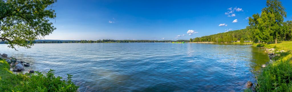 Picture of the river from Chester Frost Park in Hixson, TN.   Calm water to the other side with green trees and blue sky