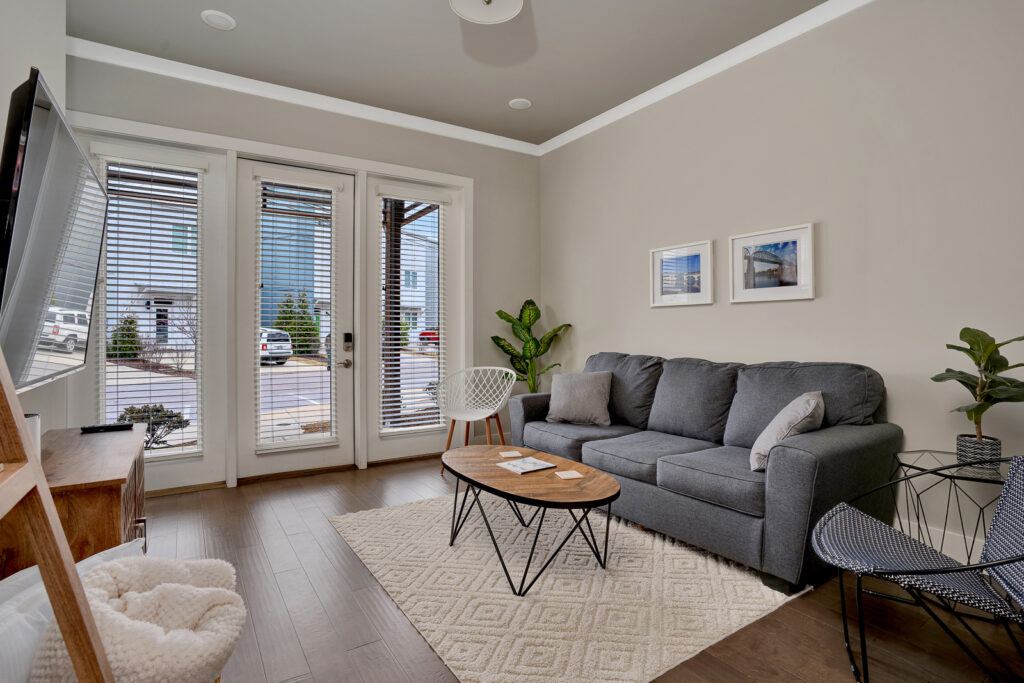 Living room for 3059 St. Elmo Ave is craftsman style with beige walls hardwood floors and couch.