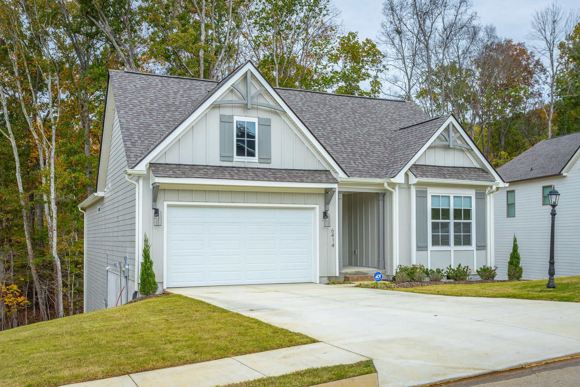 Front of 6414 Satjanon drive.  Grey siding and grey shingle roof for a one story home.