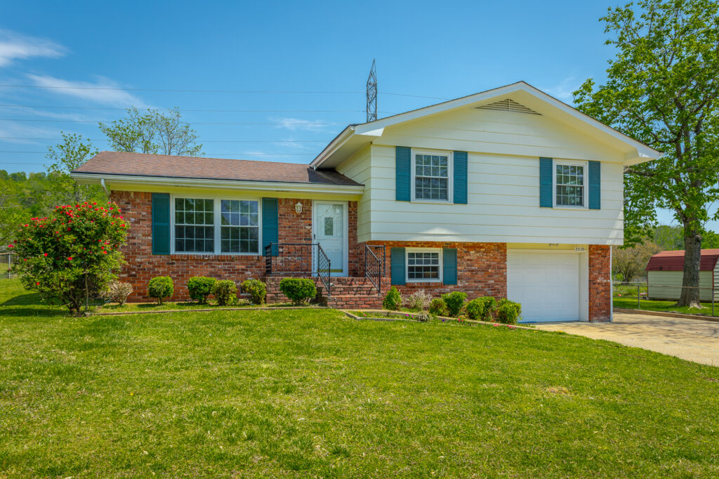 Front of 2302 Rodeo Drive a bi-level 3 bedroom 3 bathroom home with brick and siding.