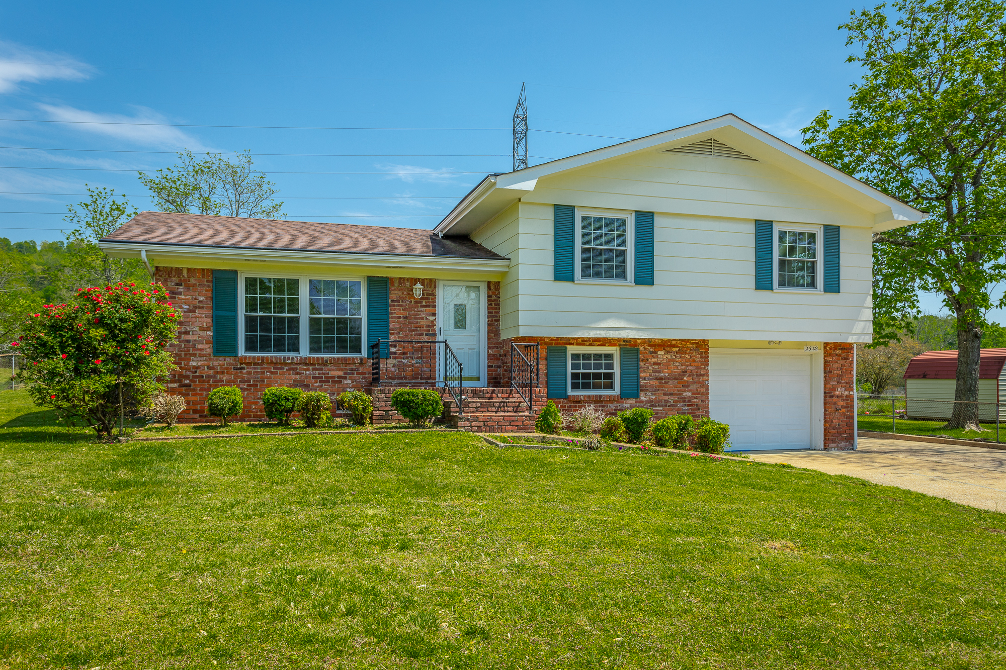 Front of 2302 Rodeo Drive a bi-level 3 bedroom 3 bathroom home with brick and siding.