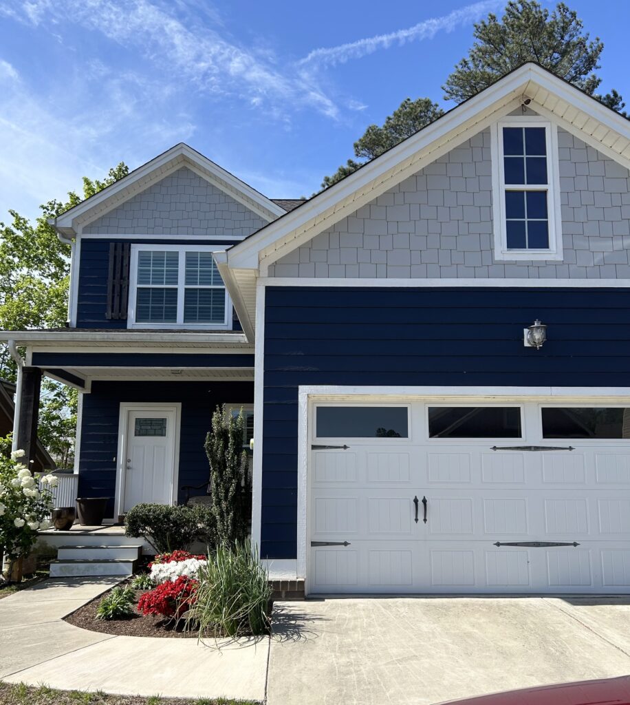 front of 229 Courtland Crest a charming 2 story dark blue craftsman home for sale