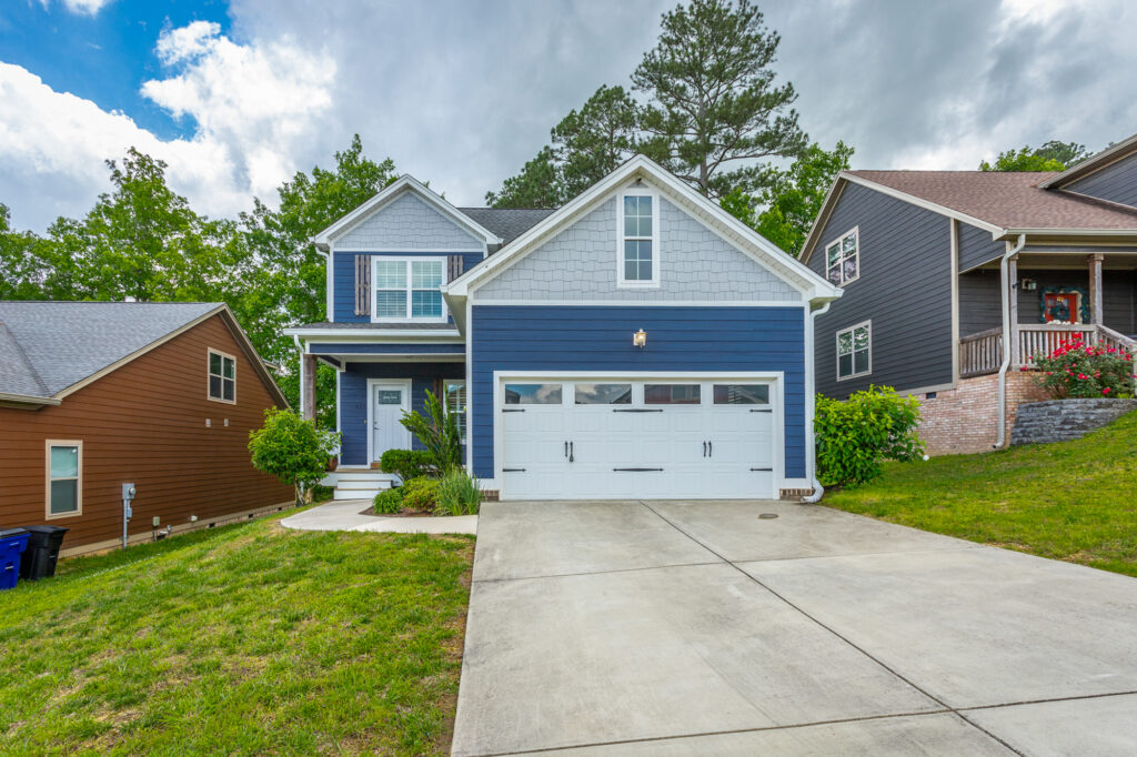 front of 229 Courtland Crest a charming 2 story dark blue craftsman home for sale