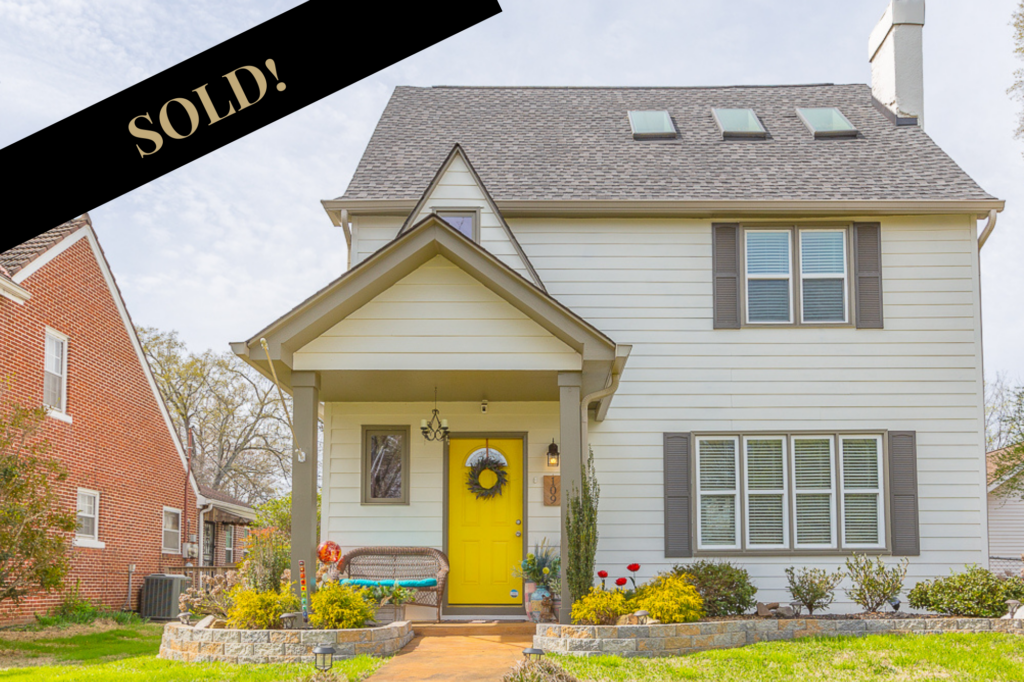 Front of 109 Asbury a two story home yellow door in Chattanooga that sold.