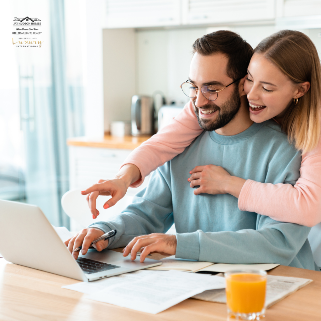 Featured image for First Home Buyers page. Image of a Happy Couple looking at computer with a glass of orange juice on the table.
