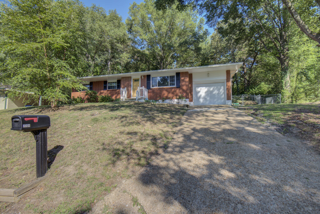 Front of 7708 Nautical Way a one story brick ranch style home for sale with 1 car garage.