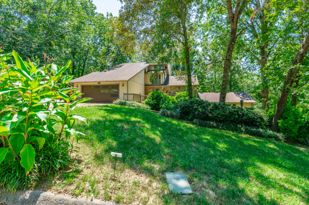 front of 9208 Magic Mountain, Contemporary style home with wooded lot.