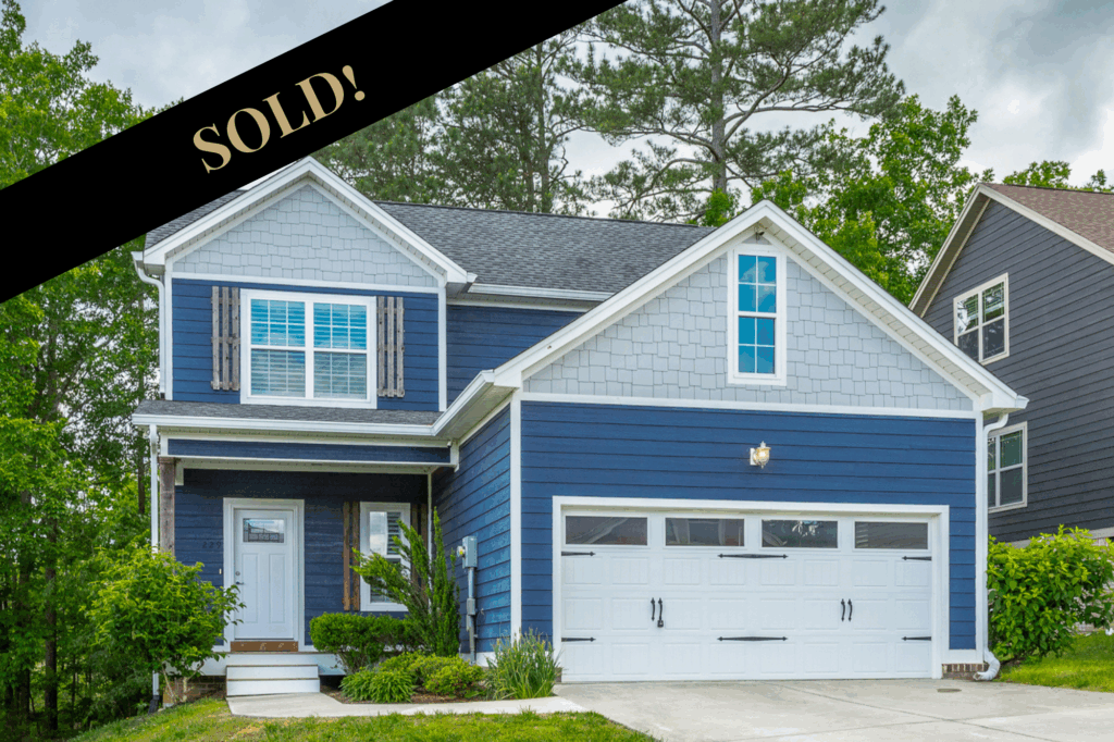 front of 229 Courtland Crest a charming 2 story dark blue craftsman home.  Sold August 2025