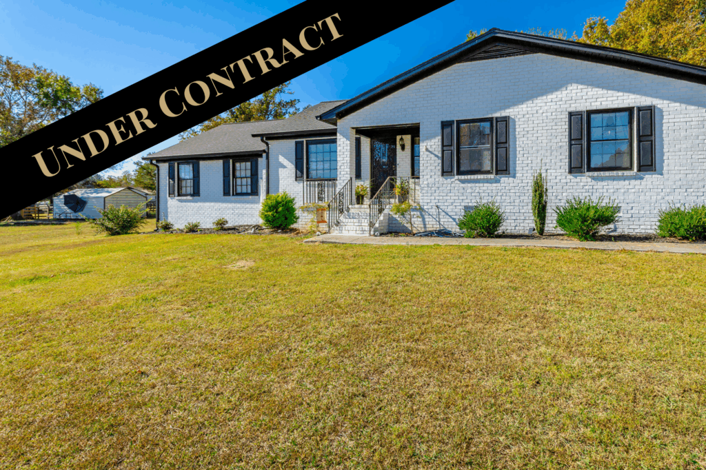 Front of 5551 NW Georgetown Road a paint white brick ranch home that is under contract